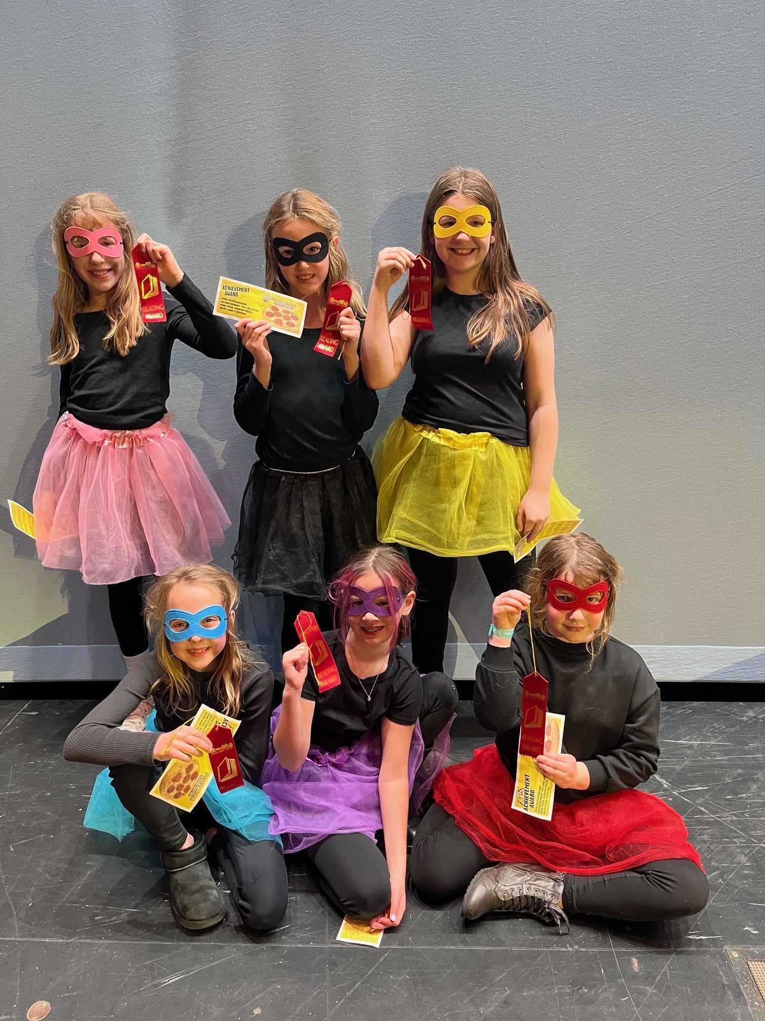 Best Team Name winners. Six girls in black shirts, different colored tutus and bandit masks.